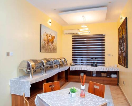a dining room with a table and chairs at A's Hospitality in Ikeja