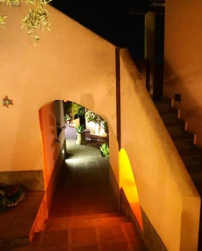 a stairway leading to a building with an arch way at Casa Spisidda Appartamento bilocale "Salina" con vista sulle Eolie in Gioiosa Marea