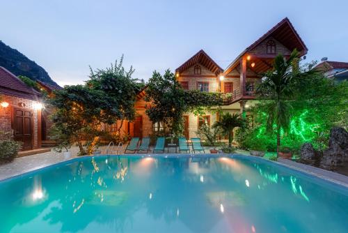 a swimming pool in front of a house at Trang An Family Homestay in Ninh Binh