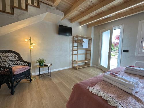 a bedroom with a large bed and a staircase at Conde Dúplex - Casal do Conde in Caldas de Reis