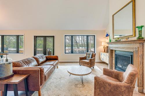 a living room with a couch and a fireplace at Lakefront Long Pond Home with Wraparound Deck! in Long Pond