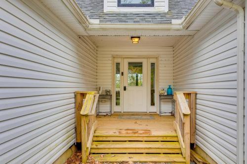 a porch of a house with a white door at Lakefront Long Pond Home with Wraparound Deck! in Long Pond