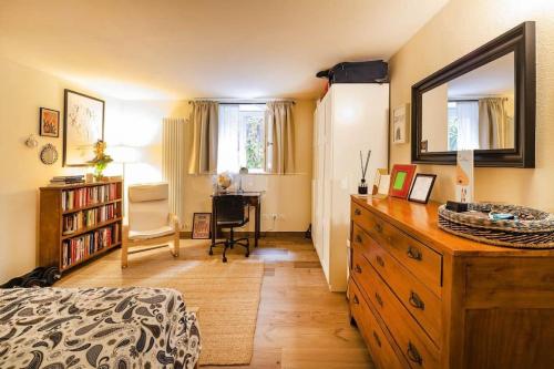 a bedroom with a dresser with a mirror and a desk at Studio Garibaldi 7 in Verona