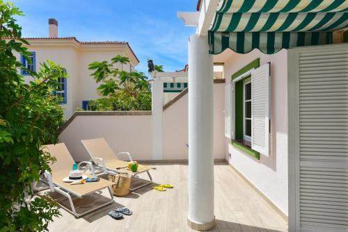 a patio with a table and chairs and an umbrella at Marina Port 15 by VillaGranCanaria in Pasito Blanco