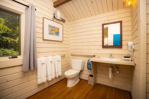 a bathroom with a toilet and a sink at Carowinds Camp Wilderness in Charlotte