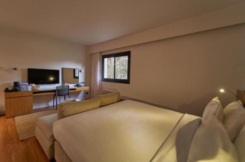 a bedroom with a bed and a couch and a desk at New President Hotel Cairo in Cairo