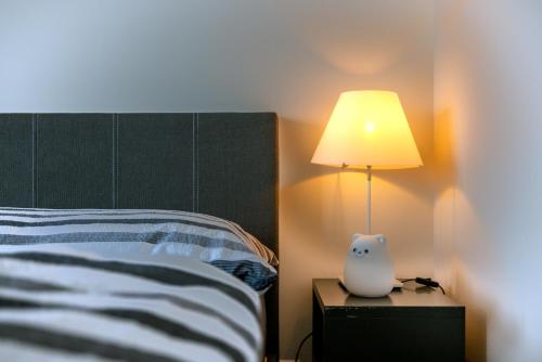 a bedroom with a bed with a lamp on a nightstand at Blattenheimat6 - im traditionellen Appenzeller Haus in Appenzell