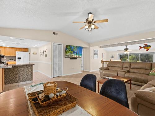 a living room with a table and a couch at *NEW* POOL screened-in, Waterfront, 4 Kayaks, Pet in Hernando Beach