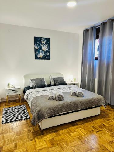 a bedroom with a bed with two towels on it at Kuća za odmor Šimun in Vukovar
