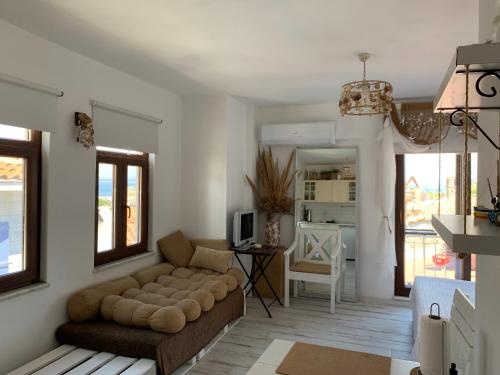 a living room with a couch and a table at Vapori Otel in Bozcaada