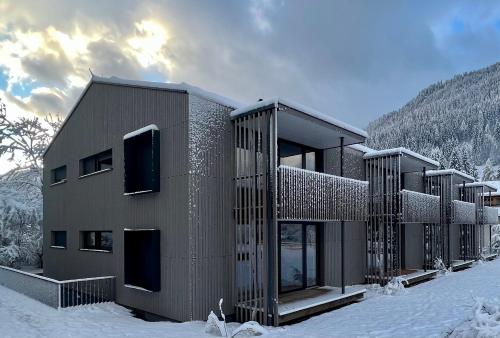 a building in the snow in the mountains at Bio Design Appartements DAS GRAUE SCHAF - Kärnten Card im Sommer inklusive in Bad Kleinkirchheim