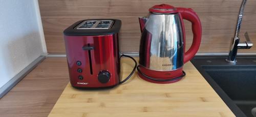 a red toaster and a coffee maker on a counter at Orelli House in Lissone