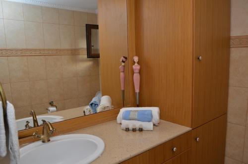a bathroom with a sink and a mirror at Villa Blu Majestic beach villa in Halki