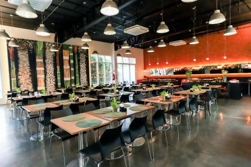 a dining room with wooden tables and chairs at Ramada by Wyndham Campinas Viracopos in Campinas