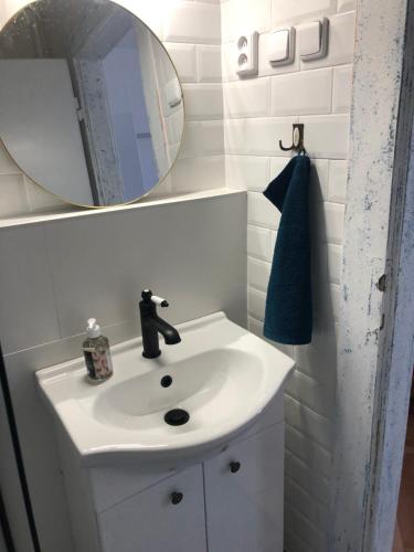 a bathroom with a white sink and a mirror at Hostel Moravia Ostrava in Ostrava