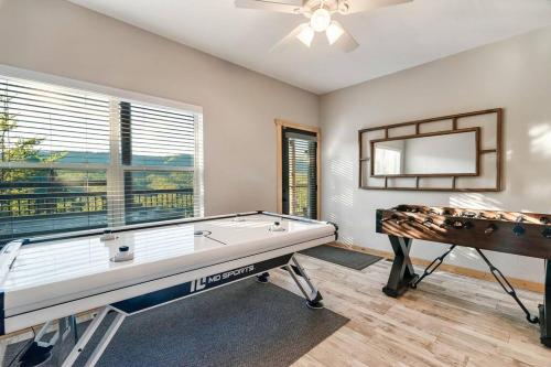 a room with a pool table and a mirror at Highland View Cabin in Pigeon Forge