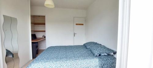 une chambre avec un lit avec une couverture bleue dans l'établissement Maison individuelle avec jardin, au calme, à Lorp Sentaraille