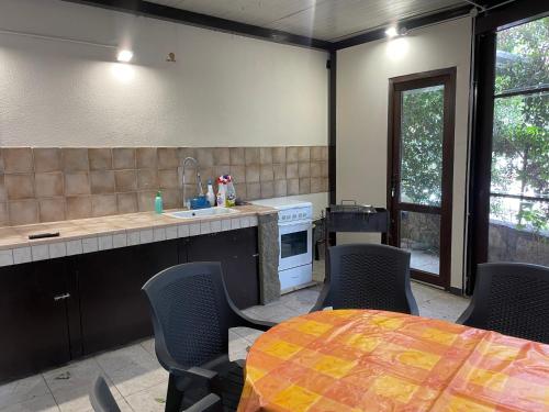 a kitchen with a table and chairs and a counter top at B&B Etna Country in Tremestieri Etneo