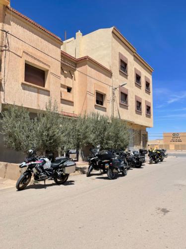 a row of motorcycles parked in front of a building at Jaddou Home in Midelt