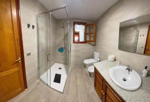 a bathroom with a shower and a sink and a toilet at Casa Marjoes - 2 Villas - BBQ - Communal Pool in Moya