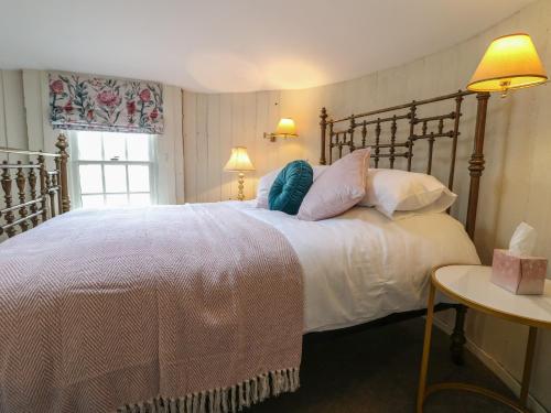 a bedroom with a large bed with white sheets and pillows at The Lazy Squire by The Water in Rugeley