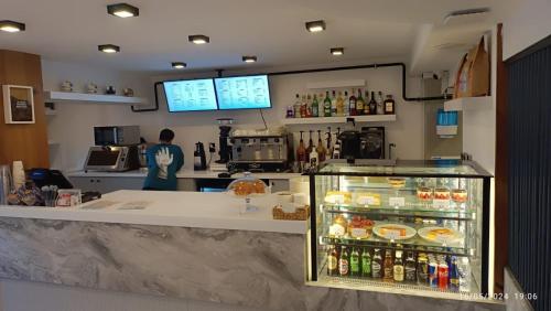 Una cocina con una encimera y un refrigerador lleno de bebidas. en Coastline, en Antalya