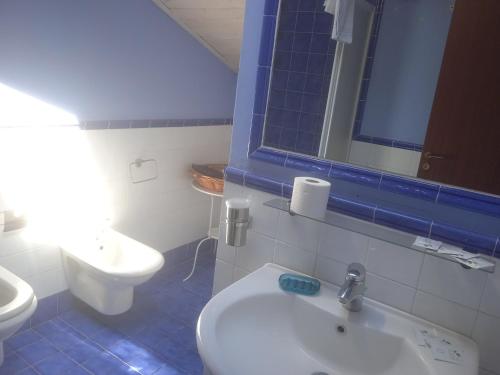 a bathroom with a sink and a toilet and a mirror at B&B Etna Country in Tremestieri Etneo