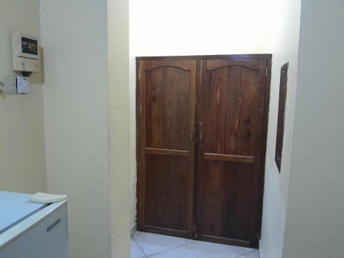 a wooden door in the corner of a kitchen at Hotel Ideal in Dar es Salaam