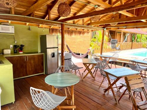 a patio with tables and chairs and a refrigerator at Anicca Aldea in Holbox Island
