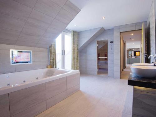 a large bathroom with a tub and a sink at The Waterside Hotel in Seamill
