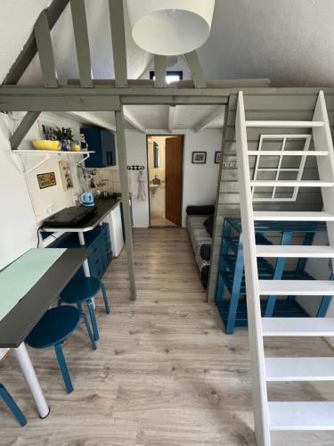 a room with a bunk bed and a desk at Domek Rybaka in Gąski