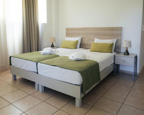 Ένα ή περισσότερα κρεβάτια σε δωμάτιο στο Ilian Beach & Apartments