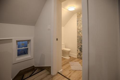 a bathroom with a toilet and a window at One Bedroom Apartment - 3 Minutes from Downtown in Ottawa