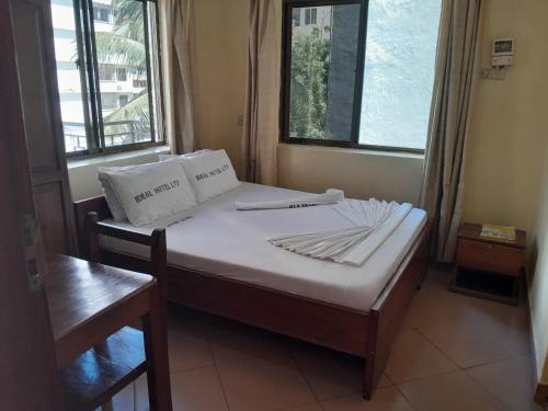 a bedroom with a bed with two pillows on it at Hotel Ideal in Dar es Salaam