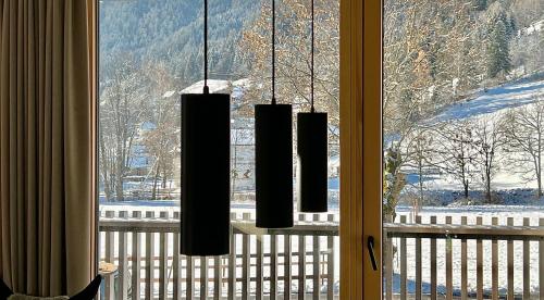 a window with a view of a snow covered mountain at Bio Design Appartements DAS GRAUE SCHAF - Kärnten Card im Sommer inklusive in Bad Kleinkirchheim