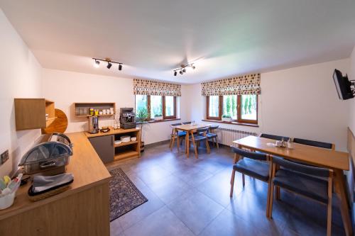 a kitchen and dining room with a table and chairs at Malinowa Dolina in Wisła