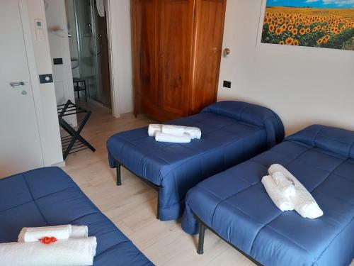 a room with three blue couches in a room at La collinetta B&B in Crespellano