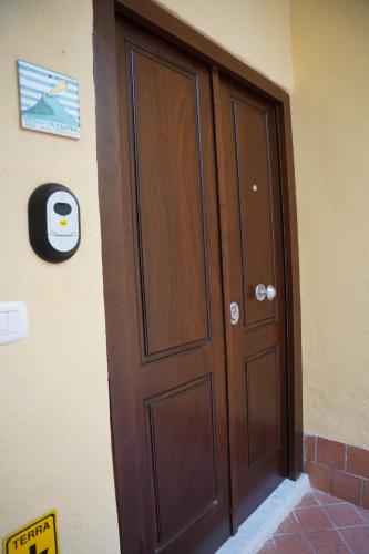 a wooden door on the side of a building at B&B Vesuvius Central in Torre del Greco