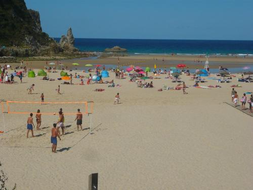 a group of people on a beach playing soccer at Apartamento 2 Bielva in Bielva