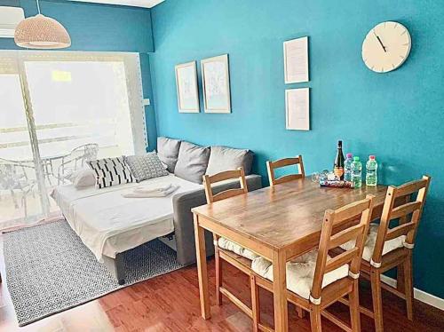 a living room with a table and a couch at Emma Sea View Suite in Larnaca
