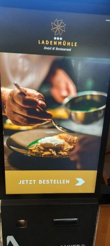 a television screen with a picture of food on it at Hotel Ladenmühle in Kurort Altenberg