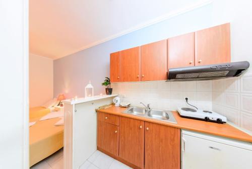 a kitchen with a sink and a bed in a room at Villa Georgia in Argassi