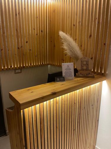 a wooden counter in a room with a wooden wall at Hotel Selfo in Gjirokastër
