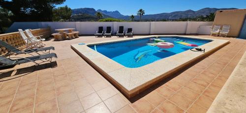 a swimming pool with a person in the middle at Casa Amina in Calpe