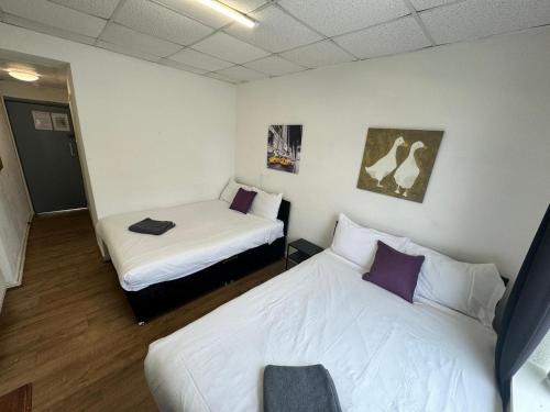 a room with two beds in a room at Burlington West hotel in Blackpool