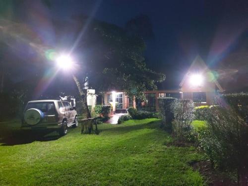 a car parked in front of a house at night at The Orange Cottage in Nyeri