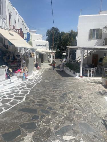 a cobblestone street in a town with white buildings at Beautiful apartment in Mykonos town ! in Mýkonos City
