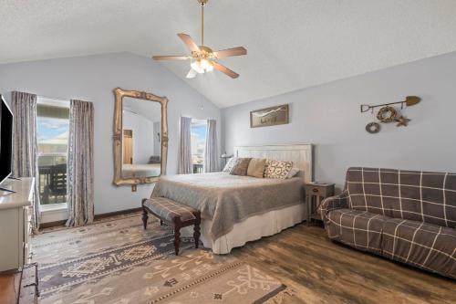 a bedroom with a bed and a couch and a mirror at Lucky Enough in Gulf Shores