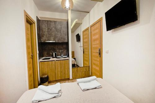a bedroom with a bed with two towels on it at Villa Montemaris Budva in Budva