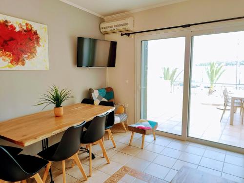 a dining room with a wooden table and chairs at Hermione Horizon in Ermioni